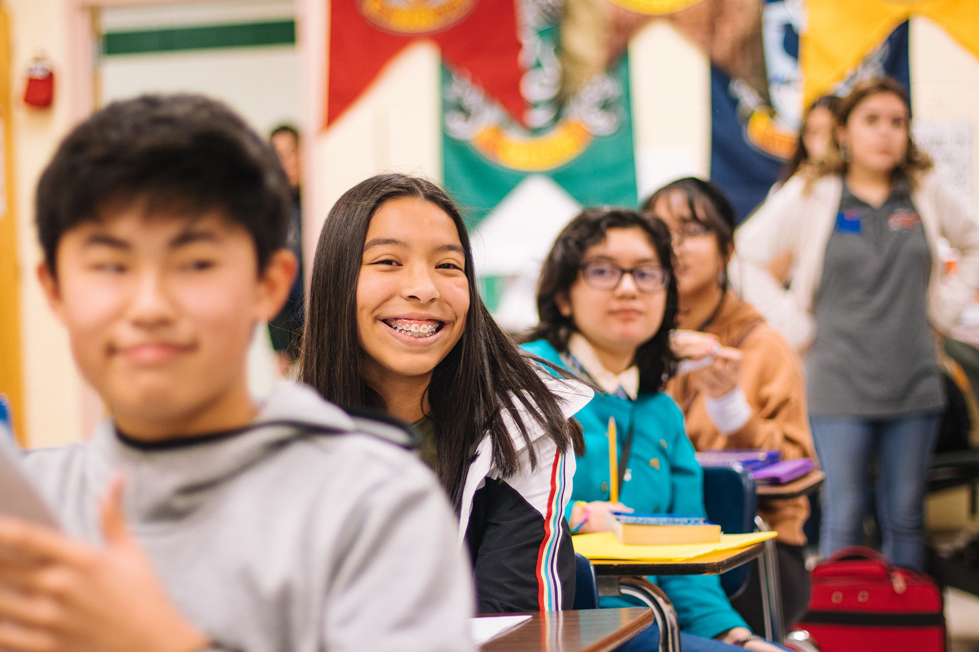 a student looking and smiling at you.